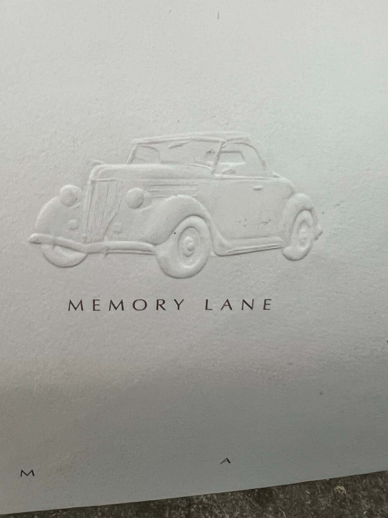 Lettering pressed into cream paper with no ink or foil